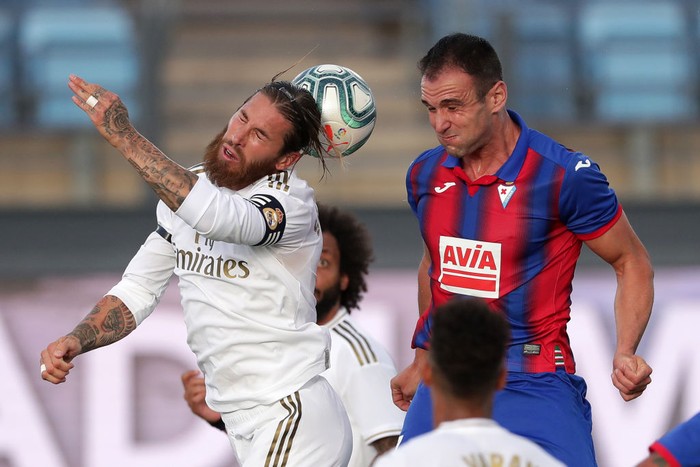 MADRID, SPAIN - JUNE 14: Sergio Ramos of Real Madrid battles for possession with Kike Garcia of Eibar  during the Liga match between Real Madrid CF and SD Eibar SAD at Estadio Alfredo Di Stefano on June 14, 2020 in Madrid, Spain. (Photo by Gonzalo Arroyo Moreno/Getty Images)