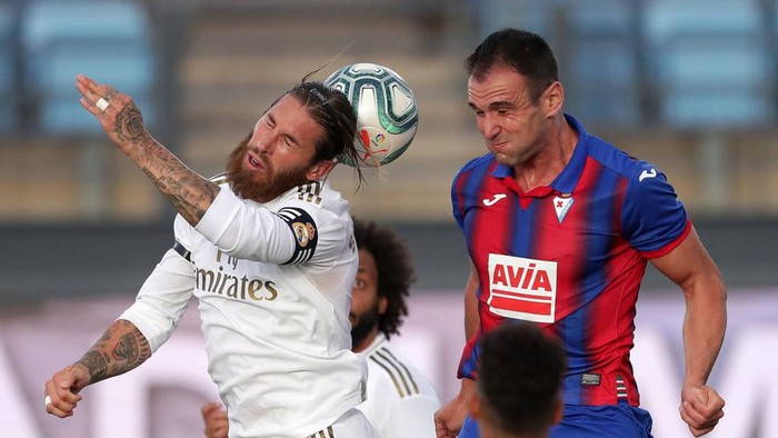 MADRID, SPAIN - JUNE 14: Sergio Ramos of Real Madrid battles for possession with Kike Garcia of Eibar  during the Liga match between Real Madrid CF and SD Eibar SAD at Estadio Alfredo Di Stefano on June 14, 2020 in Madrid, Spain. (Photo by Gonzalo Arroyo Moreno/Getty Images)