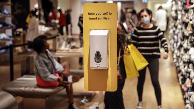 An automatic hand sanitizer dispensed is placed inside the shoes section at the Selfridges department store in London, Monday, June 15, 2020. After three months of being closed under coronavirus restrictions, shops selling fashion, toys and other non-essential goods are being allowed to reopen across England for the first time since the country went into lockdown in March.(AP Photo/Matt Dunham)