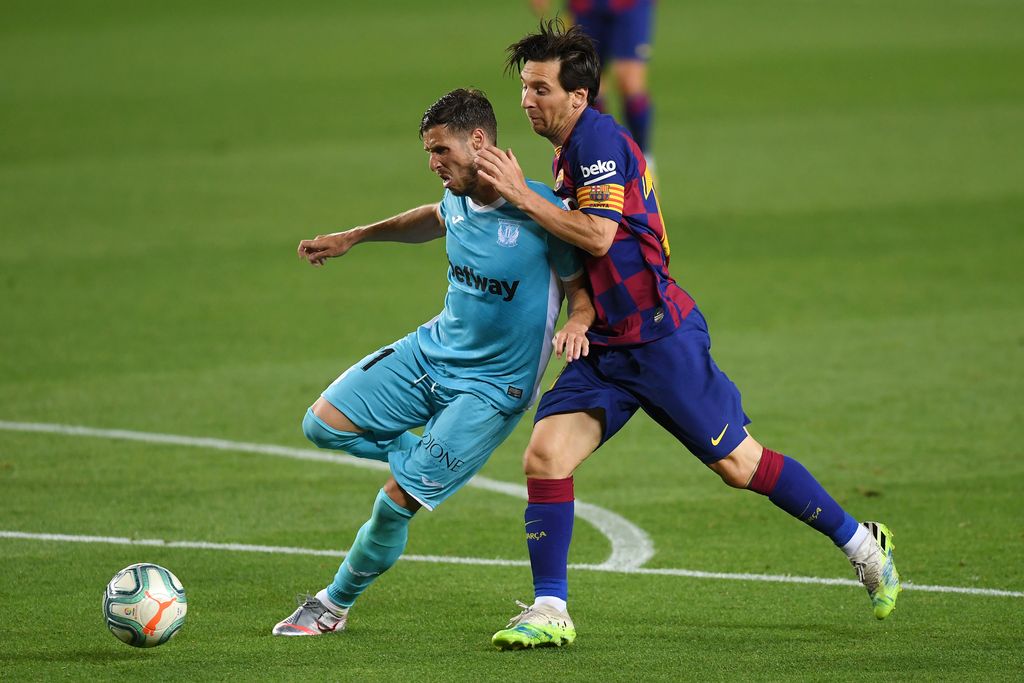 BARCELONA, SPAIN - JUNE 16: Lionel Messi of Barcelona battles for possession with Ruben Perez of Leganes  during the Liga match between FC Barcelona and CD Leganes at Camp Nou on June 16, 2020 in Barcelona, Spain. (Photo by Alex Caparros/Getty Images)