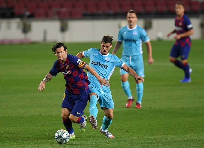 BARCELONA, SPAIN - JUNE 16: Lionel Messi of Barcelona battles for possession with Ruben Perez of Leganes  during the Liga match between FC Barcelona and CD Leganes at Camp Nou on June 16, 2020 in Barcelona, Spain. (Photo by Alex Caparros/Getty Images)
