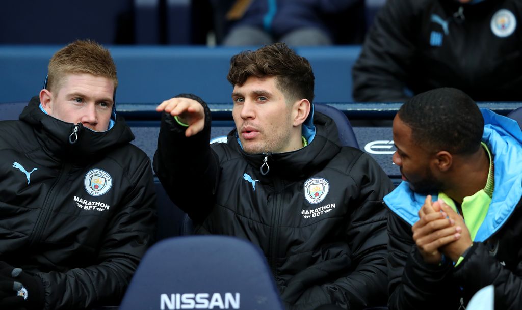 MANCHESTER, ENGLAND - JANUARY 26: Kevin De Bruyne shares a joke with John Stones of Manchester City on the bench during the FA Cup Fourth Round match between Manchester City and Fulham at Etihad Stadium on January 26, 2020 in Manchester, England. (Photo by Alex Livesey/Getty Images)