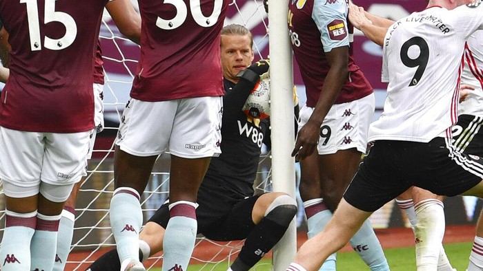 Aston Villas Oerjan Nyland saves inside the net during the English Premier League soccer match between Aston Villa and Sheffield United at Villa Park in Birmingham, England, Wednesday, June 17, 2020. The English Premier League resumes Wednesday after its three-month suspension because of the coronavirus outbreak. (Paul Ellis/Pool via AP)