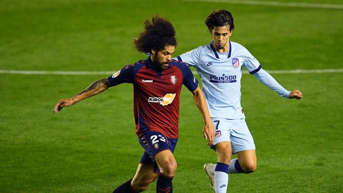 PAMPLONA, SPAIN - JUNE 17:  Joao Felix of Club Atletico de Madrid challenges Aridane Hernández Umpiérrez of CA Osasuna during the Liga match between CA Osasuna and Club Atletico de Madrid at  on June 17, 2020 in Pamplona, Spain. (Photo by David Ramos/Getty Images)