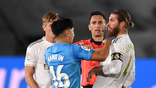 MADRID, SPAIN - JUNE 18:  Lee Kang-In of Valencia CF is shown a red card by referee José María Sánchez Martínez after a tackle on Sergio Ramos of Real Madrid CF during the Liga match between Real Madrid CF and Valencia CF at Estadio Alfredo Di Stefano on June 18, 2020 in Madrid, Spain. (Photo by Denis Doyle/Getty Images)
