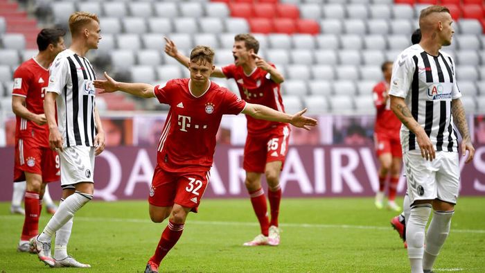 Bayern Munich vs Freiburg Munichs Joshua Kimmich, center, cheers after his opening goal during a German Bundesliga soccer match between Bayern Munich and SC Freiburg in Munich, Germany, Saturday, June, 20, 2020. (Sven Hoppe/dpa via AP)
