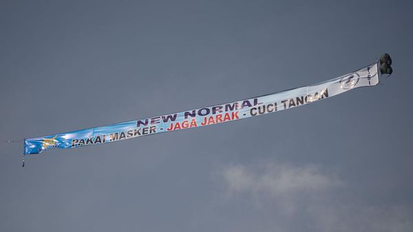 Spanduk Raksasa New Normal Mejeng di Langit Jakarta