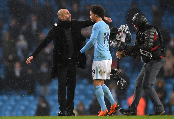 MANCHESTER, ENGLAND - MARCH 04:  Josep Guardiola, Manager of Manchester City and Leroy Sane speak following the Premier League match between Manchester City and Chelsea at Etihad Stadium on March 4, 2018 in Manchester, England.  (Photo by Shaun Botterill/Getty Images)