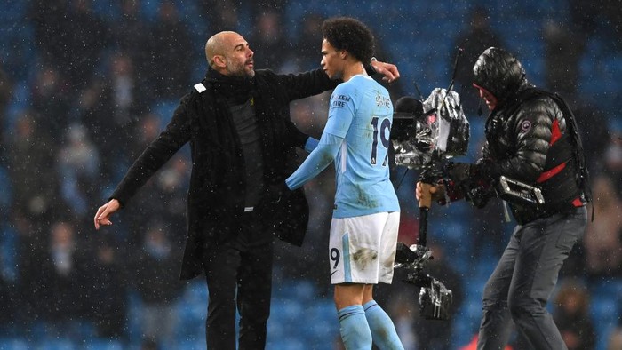MANCHESTER, ENGLAND - MARCH 04:  Josep Guardiola, Manager of Manchester City and Leroy Sane speak following the Premier League match between Manchester City and Chelsea at Etihad Stadium on March 4, 2018 in Manchester, England.  (Photo by Shaun Botterill/Getty Images)