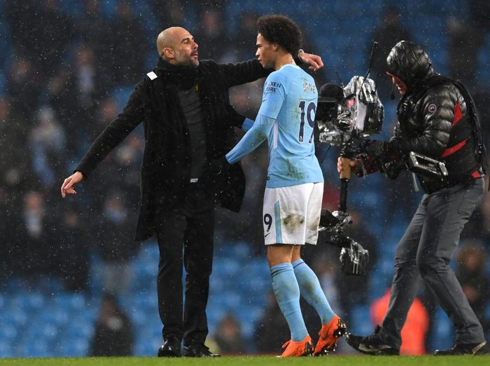 MANCHESTER, ENGLAND - MARCH 04:  Josep Guardiola, Manager of Manchester City and Leroy Sane speak following the Premier League match between Manchester City and Chelsea at Etihad Stadium on March 4, 2018 in Manchester, England.  (Photo by Shaun Botterill/Getty Images)