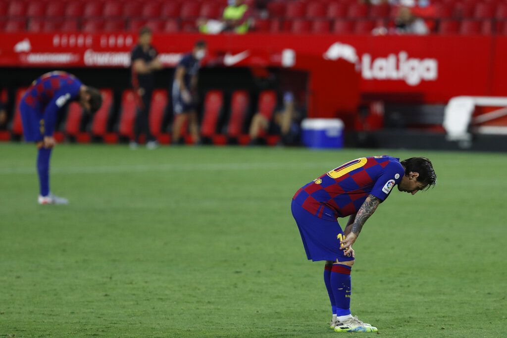 Barcelona's Lionel Messi reacts during the Spanish La Liga soccer match between Sevilla and FC Barcelona at the Ramon Sanchez-Pizjuan stadium in Seville, Spain, Friday, June 19, 2020. (AP Photo/Angel Fernandez)