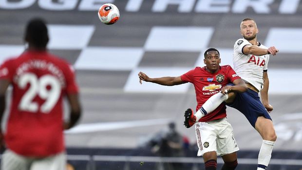 Manchester United's Anthony Martial and Tottenham's Eric Dier, right, battle for the ball during the English Premier League soccer match between Tottenham Hotspur and Manchester United at Tottenham Hotspur Stadium in London, England, Friday, June 19, 2020. (AP Photo/Glyn Kirk, Pool)