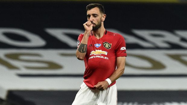 Manchester United's Bruno Fernandes reacts after kicking a penalty to level the scores during the English Premier League soccer match between Tottenham Hotspur and Manchester United at Tottenham Hotspur Stadium in London, England, Friday, June 19, 2020. (AP Photo/Glyn Kirk, Pool)