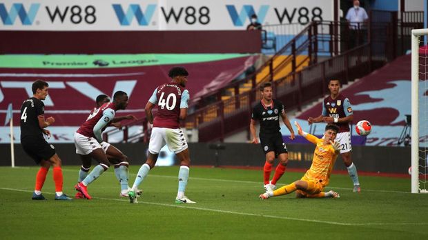 BIRMINGHAM, ENGLAND - JUNE 21: Kortney Hause of Aston Villa (obscured)  scores his team's first goal during the Premier League match between Aston Villa and Chelsea FC at Villa Park on June 21, 2020 in Birmingham, England. Football Stadiums around Europe remain empty due to the Coronavirus Pandemic as Government social distancing laws prohibit fans inside venues resulting in all fixtures being played behind closed doors. (Photo by Molly Darlington/Pool via Getty Images)