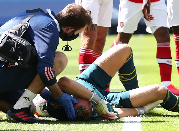 BRIGHTON, ENGLAND - JUNE 20: Bernd Leno of Arsenal receives medical treatment during the Premier League match between Brighton & Hove Albion and Arsenal FC at American Express Community Stadium on June 20, 2020 in Brighton, England. Football Stadiums around Europe remain empty due to the Coronavirus Pandemic as Government social distancing laws prohibit fans inside venues resulting in all fixtures being played behind closed doors. (Photo by Gareth Fuller/Pool via Getty Images)