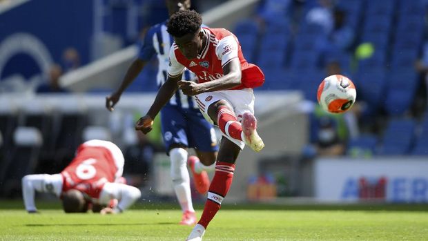 Arsenal's Bukayo Saka attempts a shot at goal during the English Premier League soccer match between Brighton & Hove Albion and Arsenal at the AMEX Stadium in Brighton, England, Saturday, June 20, 2020. (Mike Hewitt/Pool via AP)