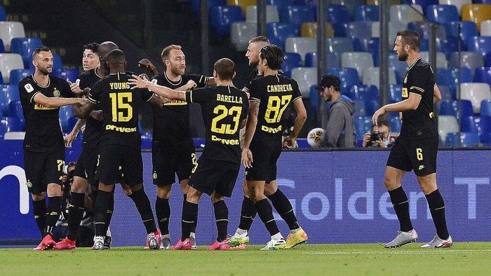 Inter Milans Christian Eriksen, 5th from right, celebrates with teammates after scoring his sides opening goal during the Italian Cup second leg semifinal soccer match between Napoli and Inter Milan, at the Naples San Paolo Stadium, Italy, Saturday, June 13, 2020. The match is being played without spectators because of the COVID-19 restriction measures. (Cafaro/LaPresse via AP)