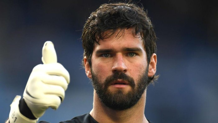 Alisson Becker LIVERPOOL, ENGLAND - JUNE 21: Alisson Becker of Liverpool shows a thumbs up while the logo in support of the NHS is seen on his shirt during the Premier League match between Everton FC and Liverpool FC at Goodison Park on June 21, 2020 in Liverpool, England. Football Stadiums around Europe remain empty due to the Coronavirus Pandemic as Government social distancing laws prohibit fans inside venues resulting in all fixtures being played behind closed doors. (Photo by Peter Powell/Pool via Getty Images)