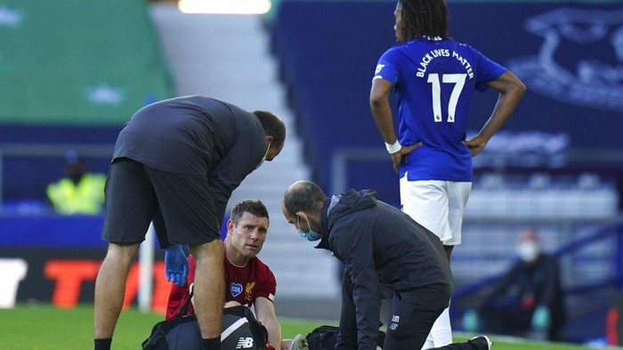 Liverpools James Milner gets injured during the English Premier League soccer match between Everton and Liverpool at Goodison Park in Liverpool, England, Sunday, June 21, 2020. (AP photo/Jon Super, Pool)