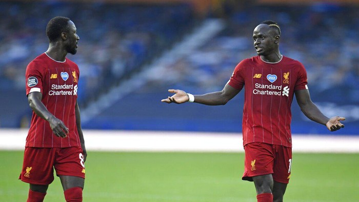 Liverpools Naby Keita, left, and Liverpools Sadio Mane discuss as they leave the pitch at half time during the English Premier League soccer match between Everton and Liverpool at Goodison Park in Liverpool, England, Sunday, June 21, 2020. (Peter Powell/Pool via AP)