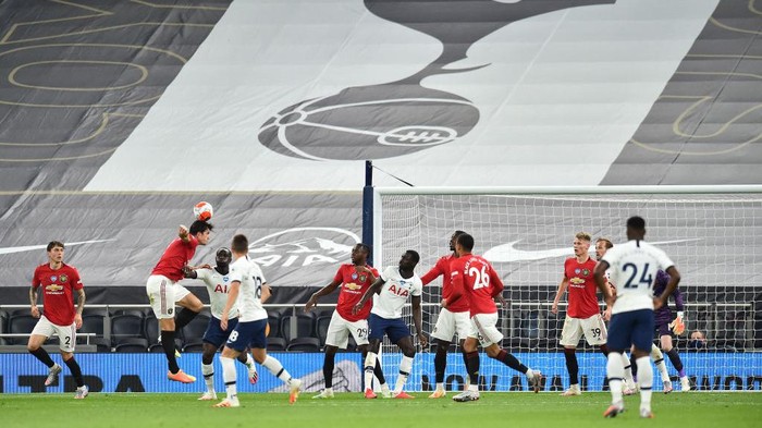 LONDON, ENGLAND - JUNE 19:  Harry Maguire of Manchester United heads the ball during the Premier League match between Tottenham Hotspur and Manchester United at Tottenham Hotspur Stadium on June 19, 2020 in London, England. (Photo by Glyn Kirk/ Pool via Getty Images)