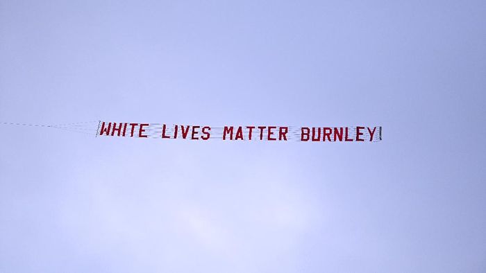 Burnley MANCHESTER, ENGLAND - JUNE 22: A plane flies over the stadium with a banner reading White Lives Matter Burnley during the Premier League match between Manchester City and Burnley FC at Etihad Stadium on June 22, 2020 in Manchester, England. Football stadiums around Europe remain empty due to the Coronavirus Pandemic as Government social distancing laws prohibit fans inside venus resulting in all fixtures being played behind closed doors. (Photo by Shaun Botterill/Getty Images)