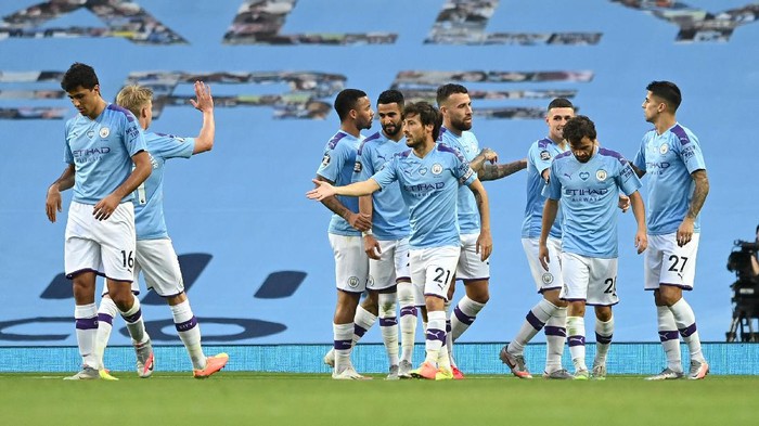 MANCHESTER, ENGLAND - JUNE 22: David Silva of Manchester City celebrates with his team mates after scoring his teams fourth goal during the Premier League match between Manchester City and Burnley FC at Etihad Stadium on June 22, 2020 in Manchester, England. Football stadiums around Europe remain empty due to the Coronavirus Pandemic as Government social distancing laws prohibit fans inside venus resulting in all fixtures being played behind closed doors. (Photo by Shaun Botterill/Getty Images)