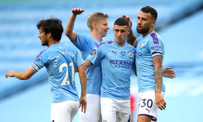 MANCHESTER, ENGLAND - JUNE 22: Phil Foden of Manchester City celebrate with his team after scoring his teams first goal during the Premier League match between Manchester City and Burnley FC at Etihad Stadium on June 22, 2020 in Manchester, England. Football stadiums around Europe remain empty due to the Coronavirus Pandemic as Government social distancing laws prohibit fans inside venues resulting in all fixtures being played behind closed doors. (Photo by Martin Rickett/Pool via Getty Images)