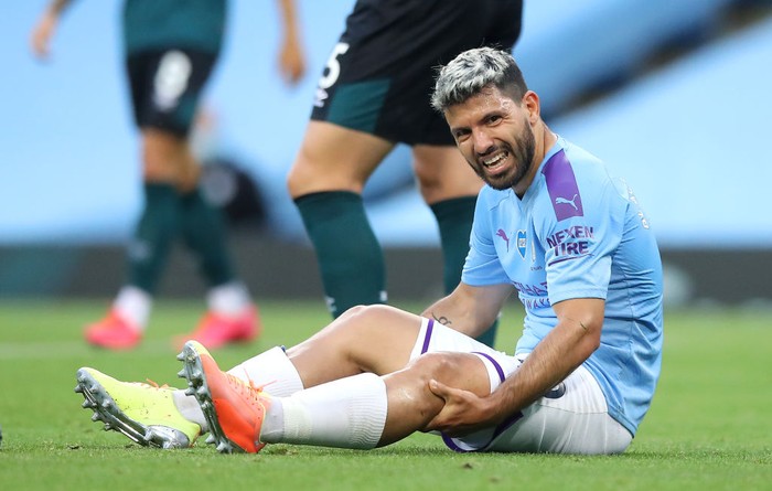 MANCHESTER, ENGLAND - JUNE 22: Sergio Aguero of Manchester City reacts while sitting on the pitch injured during the Premier League match between Manchester City and Burnley FC at Etihad Stadium on June 22, 2020 in Manchester, England. Football stadiums around Europe remain empty due to the Coronavirus Pandemic as Government social distancing laws prohibit fans inside venues resulting in all fixtures being played behind closed doors. (Photo by Martin Rickett/Pool via Getty Images)