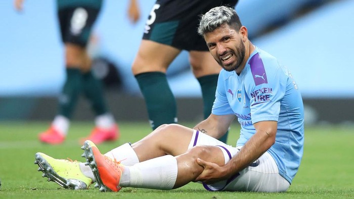 MANCHESTER, ENGLAND - JUNE 22: Sergio Aguero of Manchester City reacts while sitting on the pitch injured during the Premier League match between Manchester City and Burnley FC at Etihad Stadium on June 22, 2020 in Manchester, England. Football stadiums around Europe remain empty due to the Coronavirus Pandemic as Government social distancing laws prohibit fans inside venues resulting in all fixtures being played behind closed doors. (Photo by Martin Rickett/Pool via Getty Images)