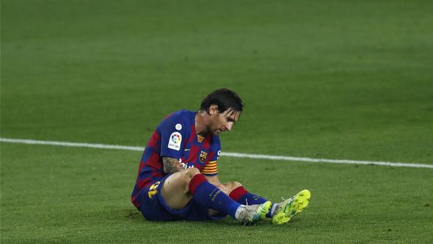 Barcelona's Lionel Messi lies on the pitch during the Spanish La Liga soccer match between FC Barcelona and Athletic Bilbao at the Camp Nou stadium in Barcelona, Spain, Tuesday, June 23, 2020. (AP Photo/Joan Monfort)