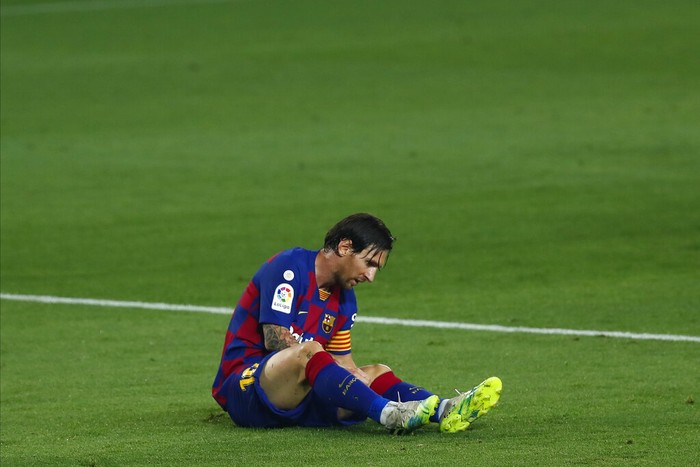 Barcelonas Lionel Messi lies on the pitch during the Spanish La Liga soccer match between FC Barcelona and Athletic Bilbao at the Camp Nou stadium in Barcelona, Spain, Tuesday, June 23, 2020. (AP Photo/Joan Monfort)