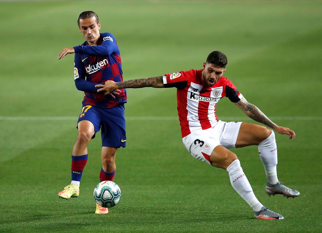 BARCELONA, SPAIN - JUNE 23: Lionel Messi of Barcelona takes on Unai Lopez of Athletic Bilbao during the Liga match between FC Barcelona and Athletic Club at Camp Nou on June 23, 2020 in Barcelona, Spain. Football Stadiums around Europe remain empty due to the Coronavirus Pandemic as Government social distancing laws prohibit fans inside venues resulting in all fixtures being played behind closed doors. (Photo by Eric Alonso/Getty Images)