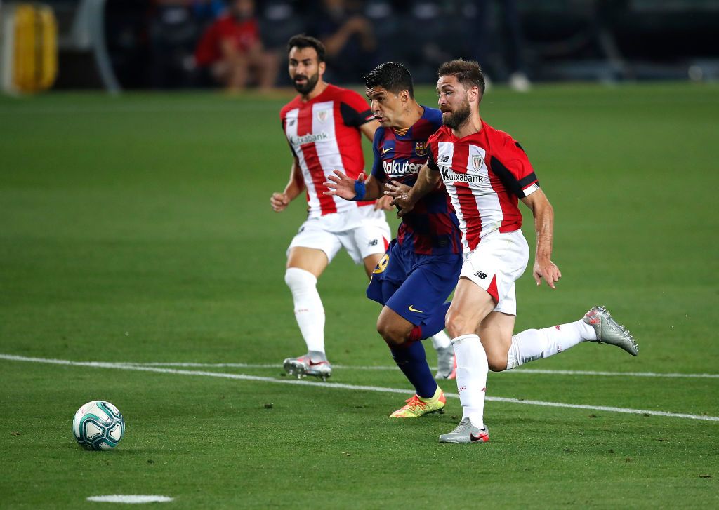BARCELONA, SPAIN - JUNE 23: Lionel Messi of Barcelona takes on Unai Lopez of Athletic Bilbao during the Liga match between FC Barcelona and Athletic Club at Camp Nou on June 23, 2020 in Barcelona, Spain. Football Stadiums around Europe remain empty due to the Coronavirus Pandemic as Government social distancing laws prohibit fans inside venues resulting in all fixtures being played behind closed doors. (Photo by Eric Alonso/Getty Images)