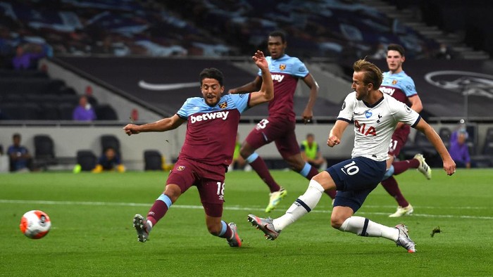 LONDON, ENGLAND - JUNE 23: Harry Kane of Tottenham Hotspur shoots under pressure from Pablo Fornals of West Ham United during the Premier League match between Tottenham Hotspur and West Ham United at Tottenham Hotspur Stadium on June 23, 2020 in London, England. Football Stadiums around Europe remain empty due to the Coronavirus Pandemic as Government social distancing laws prohibit fans inside venues resulting in all fixtures being played behind closed doors. (Photo by Neil Hall/Pool via Getty Images)