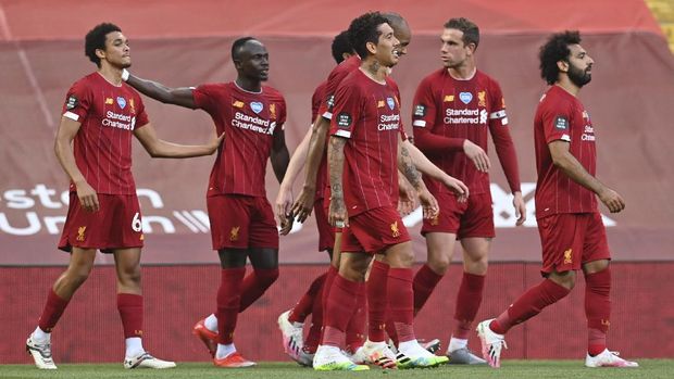 Britain Soccer Premier League Liverpool's Trent Alexander-Arnold, left, celebrates after scoring the opening goal during the English Premier League soccer match between Liverpool and Crystal Palace at Anfield Stadium in Liverpool, England, Wednesday, June 24, 2020. (Paul Ellis/Pool via AP)