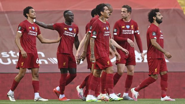 Liverpool's Trent Alexander-Arnold, left, celebrates after scoring the opening goal during the English Premier League soccer match between Liverpool and Crystal Palace at Anfield Stadium in Liverpool, England, Wednesday, June 24, 2020. (Paul Ellis/Pool via AP)