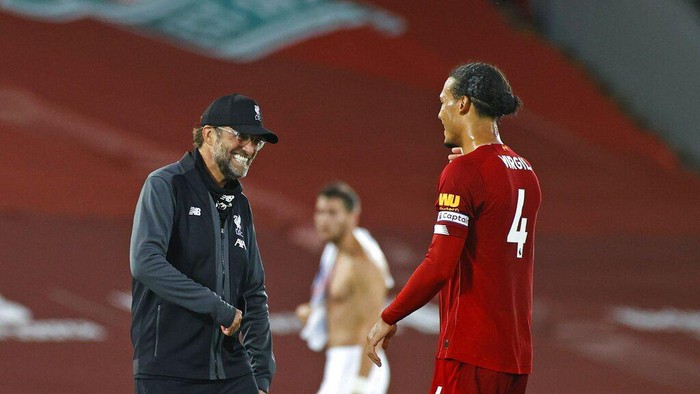 Liverpools manager Jurgen Klopp celebrates with Liverpools Virgil van Dijk after the English Premier League soccer match between Liverpool and Crystal Palace at Anfield Stadium in Liverpool, England, Wednesday, June 24, 2020. Liverpool won the match 4-0. (Phil Noble/Pool via AP)