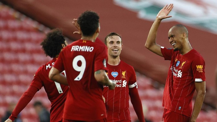 Liverpools Fabinho, right, celebrates scoring his sides third goal during the English Premier League soccer match between Liverpool and Crystal Palace at Anfield Stadium in Liverpool, England, Wednesday, June 24, 2020. (Phil Noble/Pool via AP)
