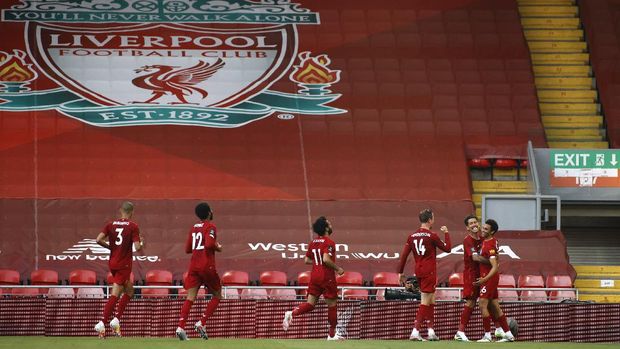 Liverpool's Trent Alexander-Arnold, right, celebrates after scoring the opening goal during the English Premier League soccer match between Liverpool and Crystal Palace at Anfield Stadium in Liverpool, England, Wednesday, June 24, 2020. (Phil Noble/Pool via AP)