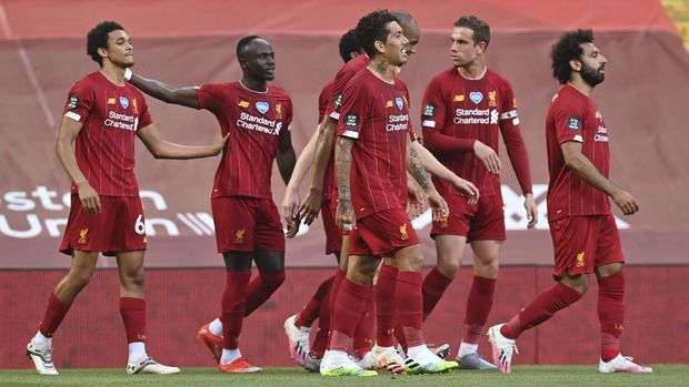 Liverpool's Trent Alexander-Arnold, left, celebrates after scoring the opening goal during the English Premier League soccer match between Liverpool and Crystal Palace at Anfield Stadium in Liverpool, England, Wednesday, June 24, 2020. (Paul Ellis/Pool via AP)