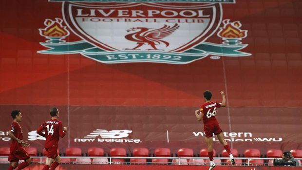 Liverpool's Trent Alexander-Arnold, right, celebrates after scoring the opening goal during the English Premier League soccer match between Liverpool and Crystal Palace at Anfield Stadium in Liverpool, England, Wednesday, June 24, 2020. (Phil Noble/Pool via AP)