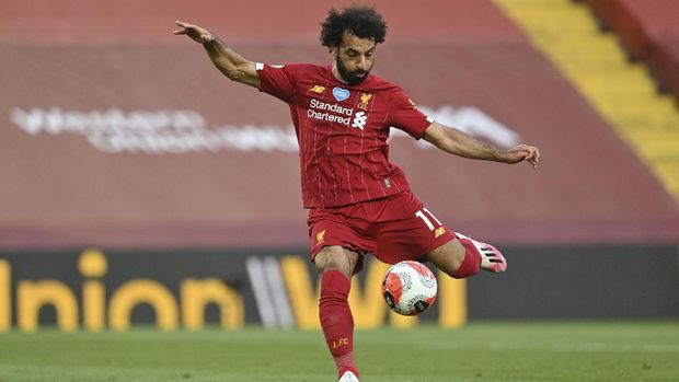Liverpool's Mohamed Salah scores the second goal during the English Premier League soccer match between Liverpool and Crystal Palace at Anfield Stadium in Liverpool, England, Wednesday, June 24, 2020. (Paul Ellis/Pool via AP)