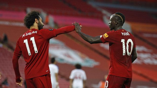 Liverpool's Sadio Mane, right, celebrates scoring his side's fourth goal with Mo Salah during the English Premier League soccer match between Liverpool and Crystal Palace at Anfield Stadium in Liverpool, England, Wednesday, June 24, 2020. (Phil Noble/Pool via AP)