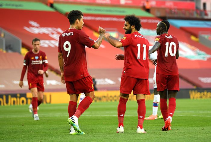 Liverpool LIVERPOOL, ENGLAND - JUNE 24: Mohamed Salah of Liverpool celebrates with Roberto Firmino of Liverpool after scoring his teams second goal during the Premier League match between Liverpool FC and Crystal Palace at Anfield on June 24, 2020 in Liverpool, England. (Photo by Shaun Botterill/Getty Images)