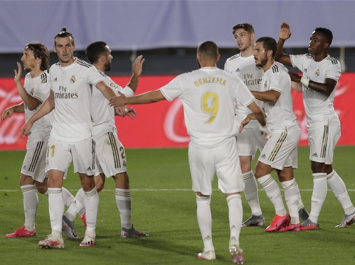 Real Madrids Vinicius Junior, right, celebrates after scoring the opening goal with teammates during the Spanish La Liga soccer match between Real Madrid and Mallorca at Alfredo di Stefano stadium in Madrid, Spain, Wednesday, June 24, 2020. (AP Photo/Bernat Armangue)