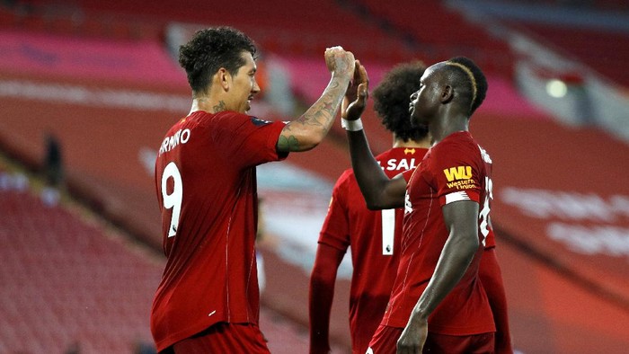 LIVERPOOL, ENGLAND - JUNE 24: Sadio Mane of Liverpool celebrates with Roberto Firmino of Liverpool after scoring his sides fourth goal during the Premier League match between Liverpool FC and Crystal Palace at Anfield on June 24, 2020 in Liverpool, England. (Phil Noble/Pool via Getty Images)