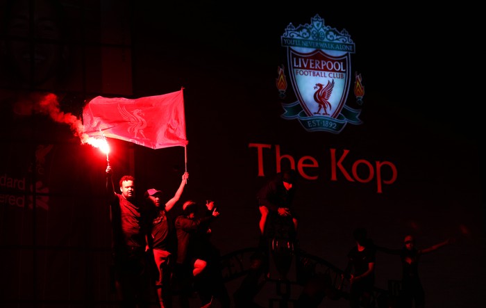LIVERPOOL, ENGLAND - JUNE 25:  Liverpool fans celebrate as their team clinches the Premier League title at Anfield on June 25, 2020 in Liverpool, England. Liverpool are crowned Premier League champions as nearest rivals Manchester City fail to beat Chelsea. Liverpool claim their first championship in 30 years. (Photo by Jan Kruger/Getty Images)