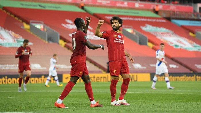 LIVERPOOL, ENGLAND - JUNE 24:  Mohamed Salah of Liverpool celebrates with Sadio Mane of Liverpool after scoring his sides second goal during the Premier League match between Liverpool FC and Crystal Palace at Anfield on June 24, 2020 in Liverpool, England. (Photo by Shaun Botterill/Getty Images)