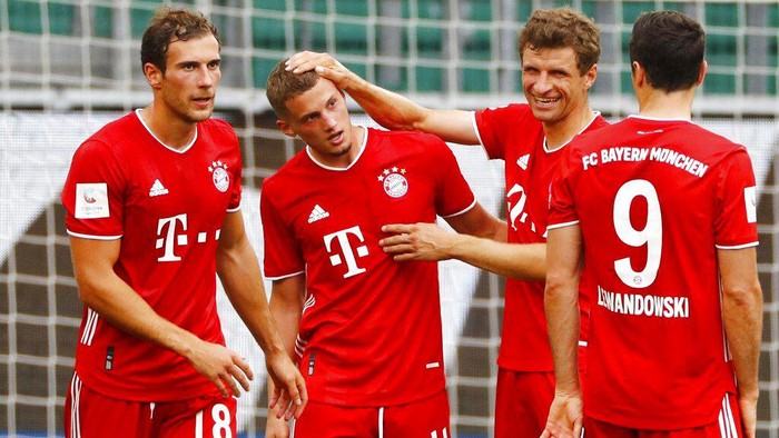 Munichs scorer Mickael Cuisance, second left, and his teammates celebrate their sides second goal   during the German Bundesliga soccer match between VfL Wolfsburg and FC Bayern Munich in Wolfsburg, Germany, Saturday, June 27, 2020. (Kai Pfaffenbach/Pool Photo via AP)